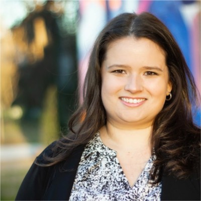 A headshot of a brunette woman smiling in Wake County