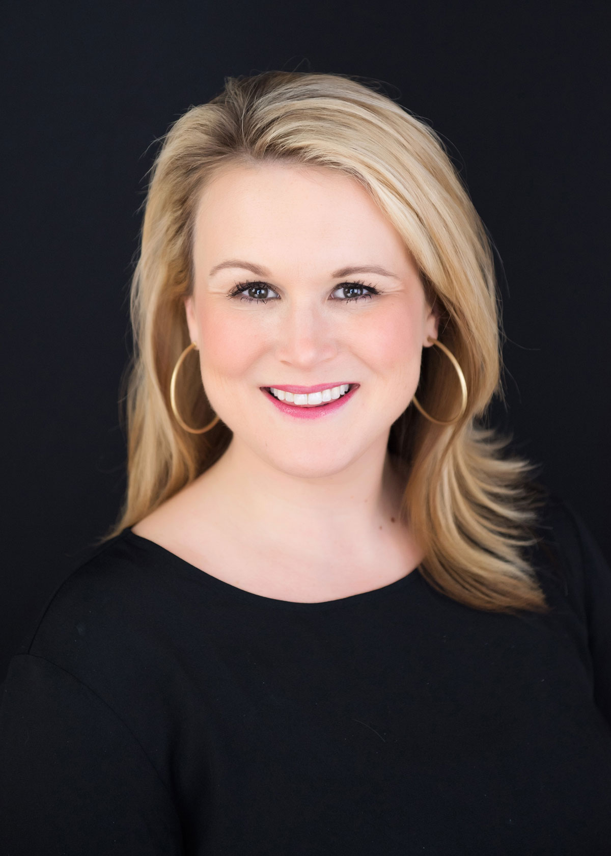 A headshot of a blonde woman smiling in Wake County