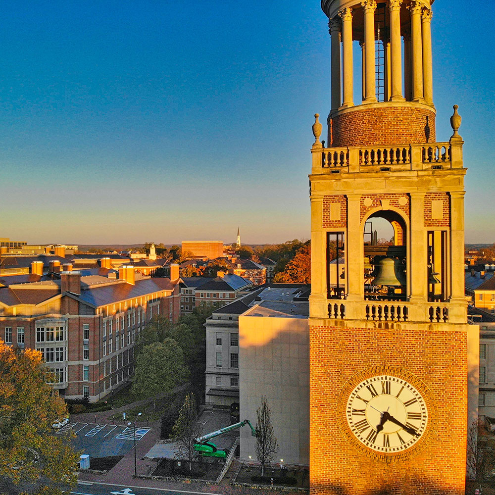 An aerial view of the University of North Carolina Bell Tower overlooking brick buildings on campus in Wake County