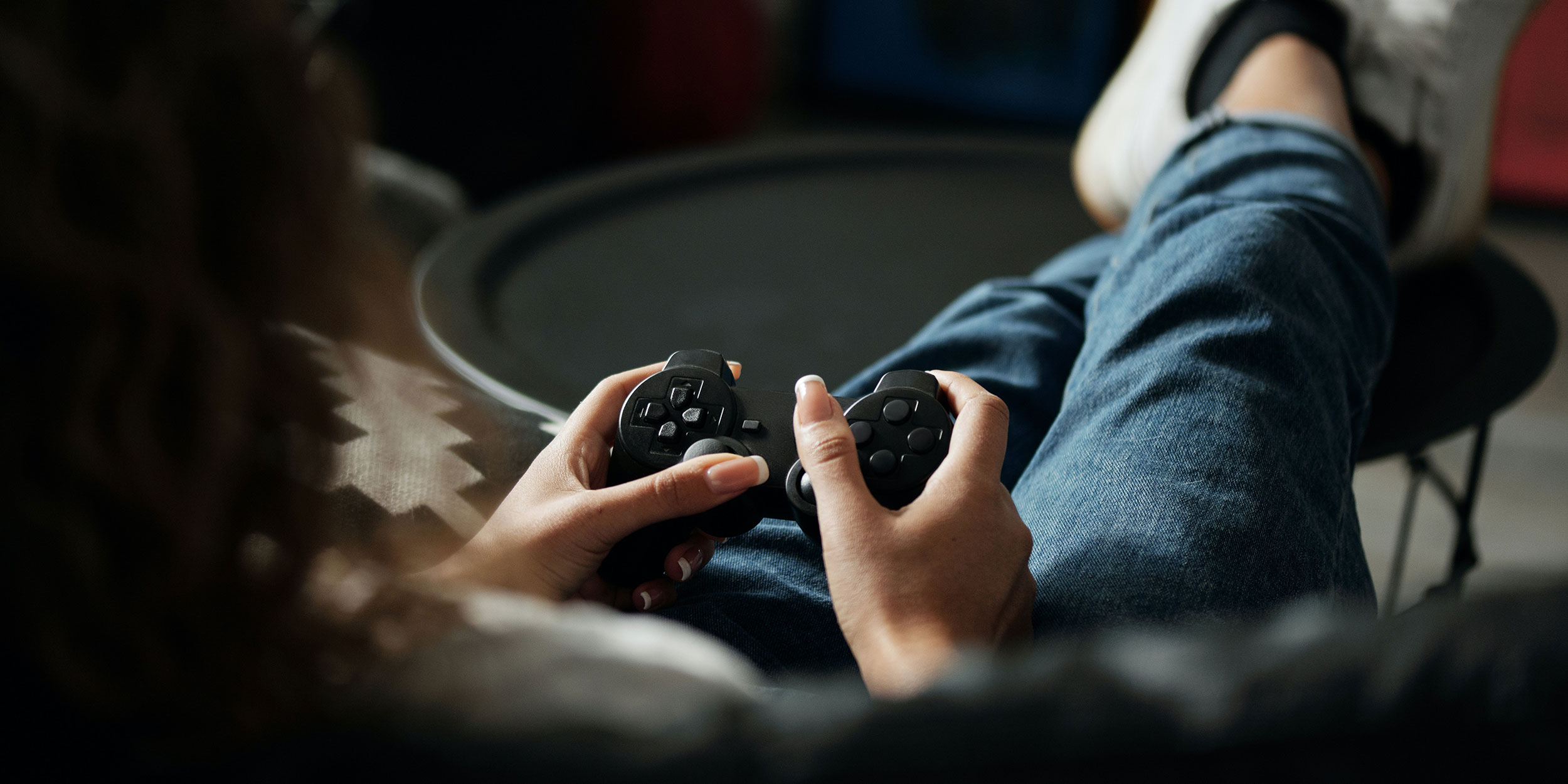 A person sits on the couch playing video games