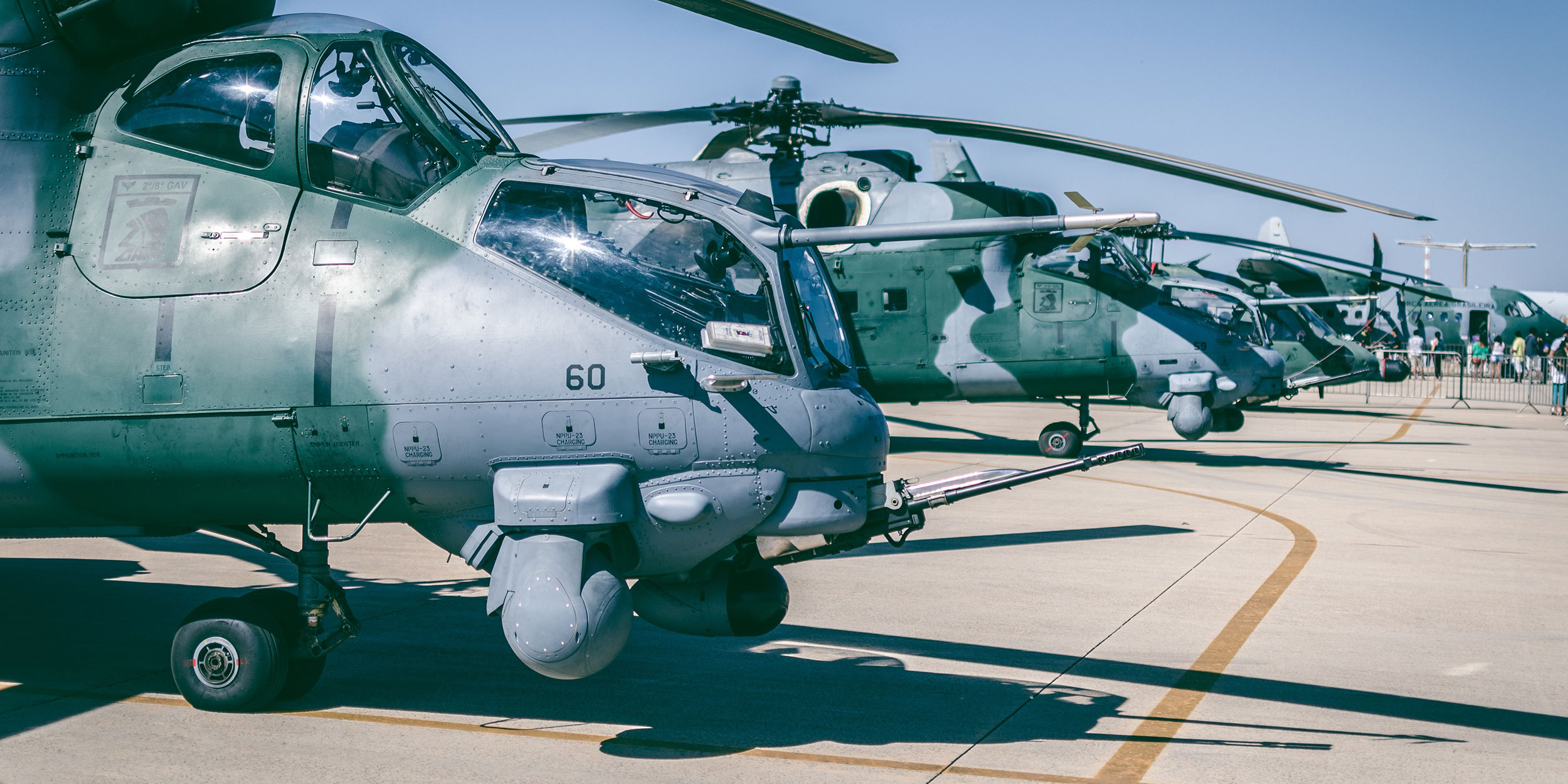 Military helicopters lined up in a row