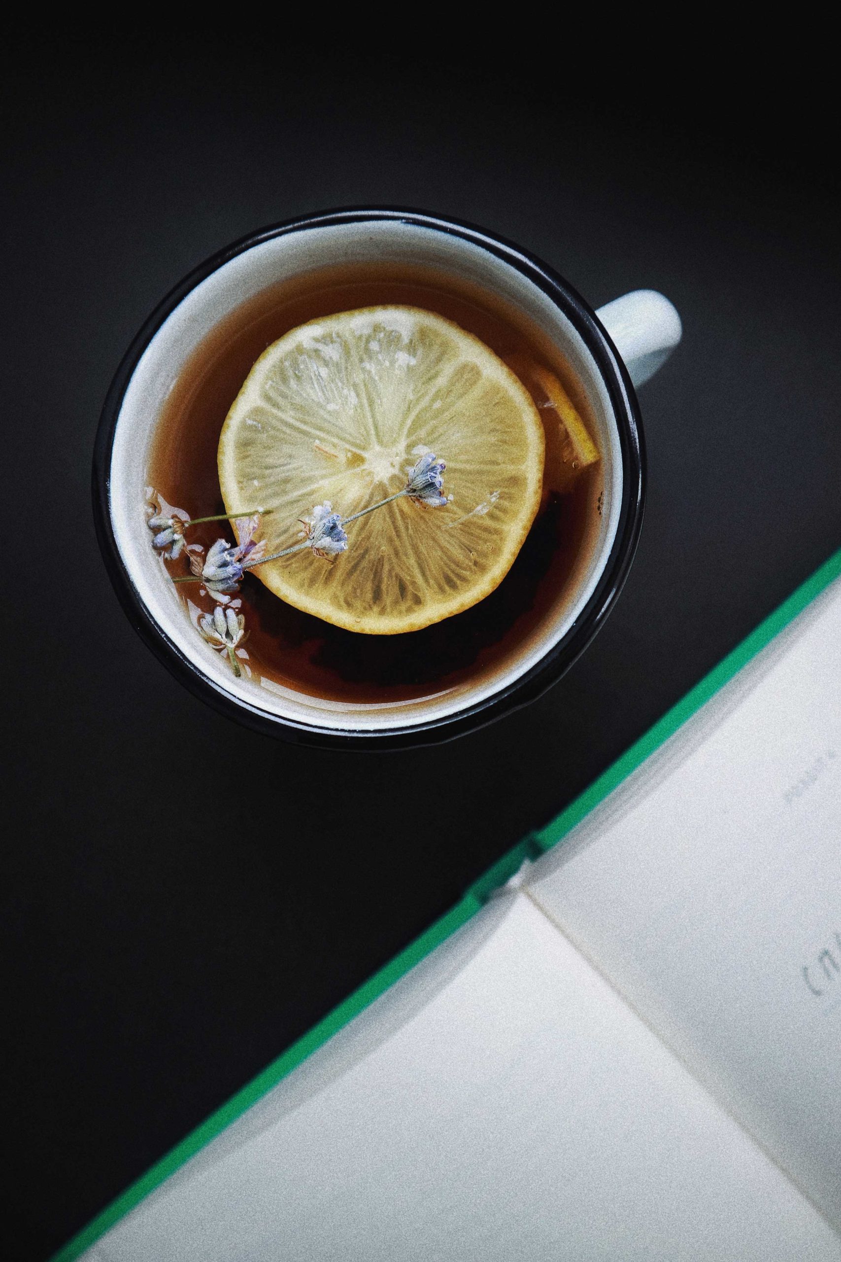 Aerial view of hot tea with lemon slice floating on the surface