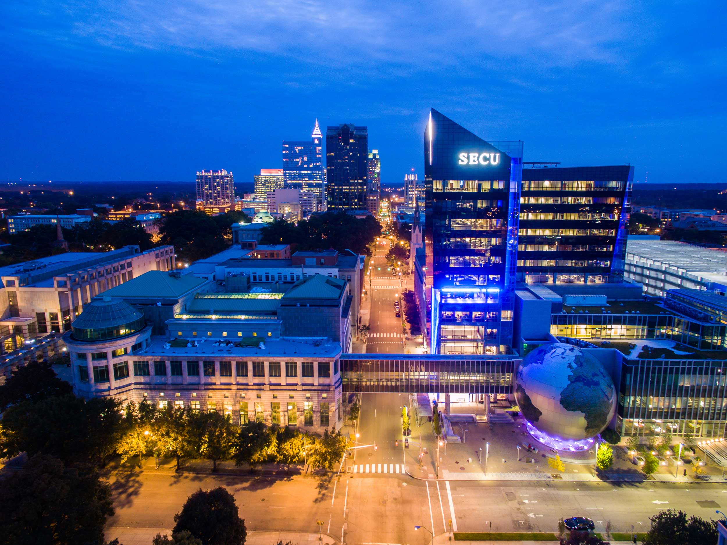 A purple sky illuminates a night time city skyline in Wake County