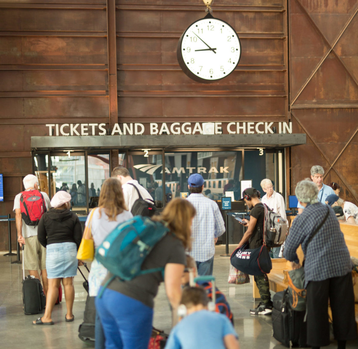 people waiting in line at the tickets and baggage checkin