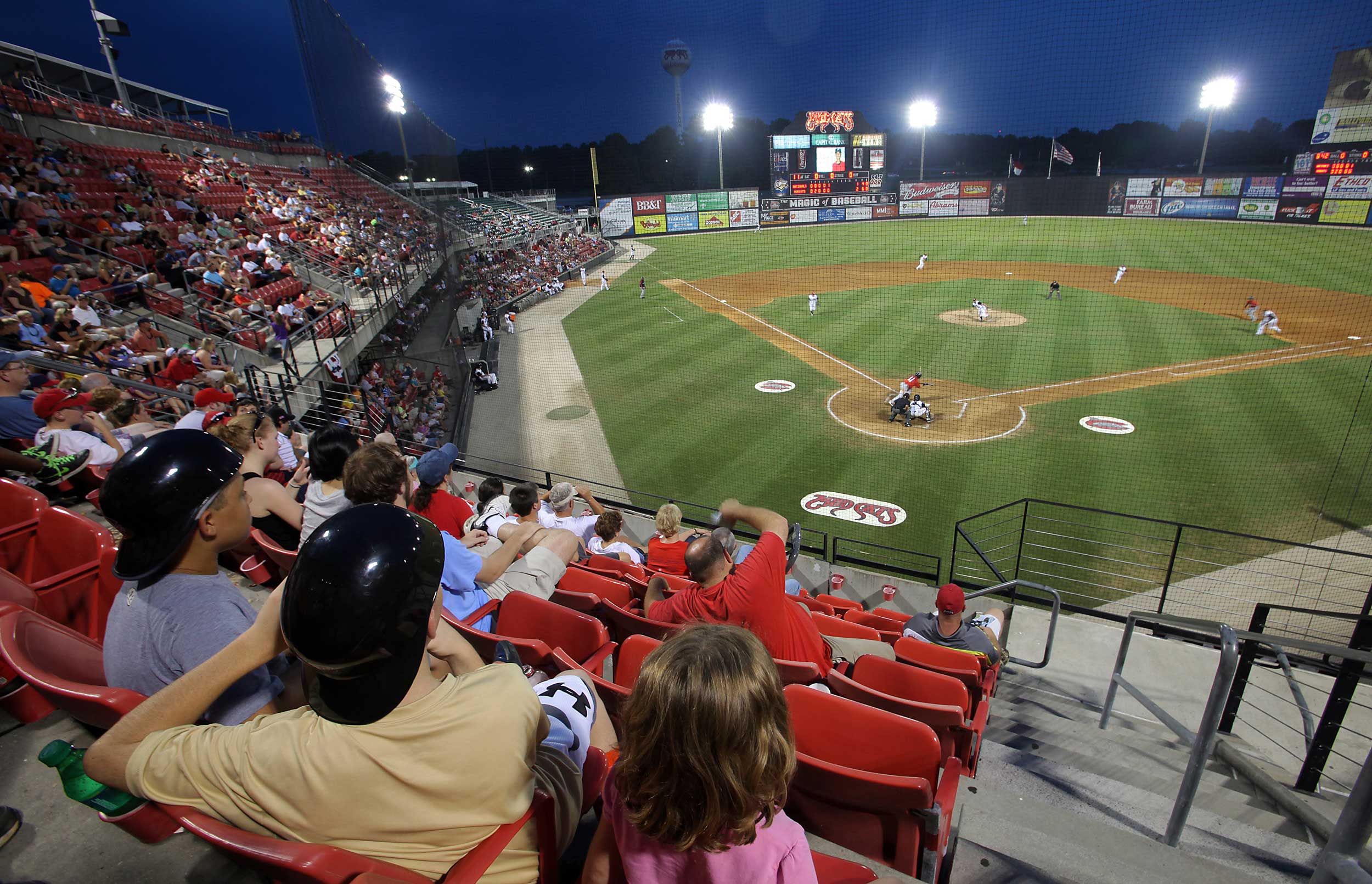 A crowd watches a baseball game.